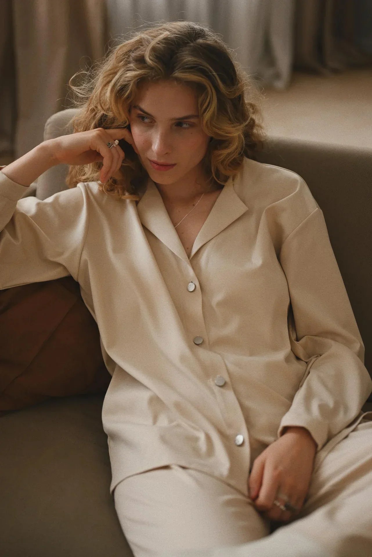 A woman wearing beige shirt