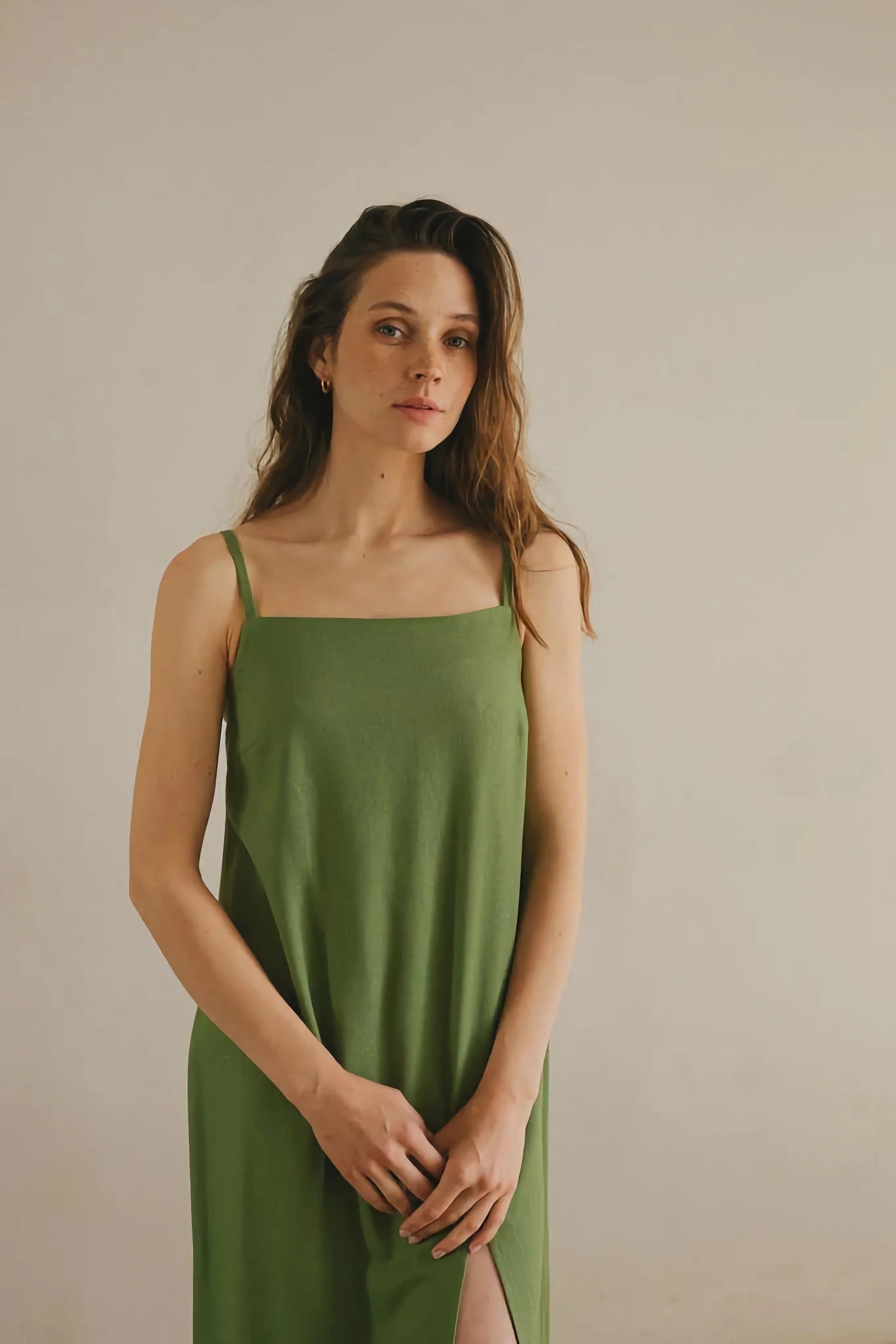 A woman wearing sleeveless linen dress