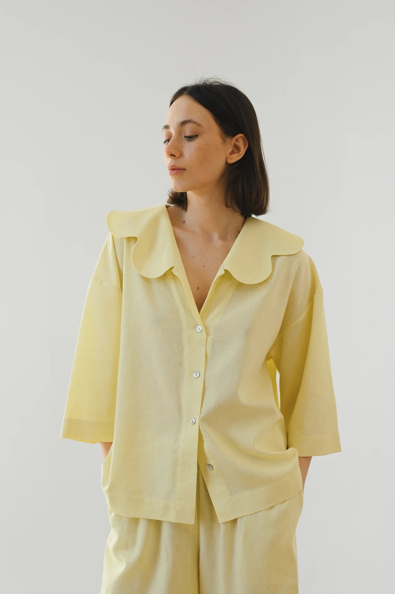 Woman wearing a light yellow blouse and matching pants