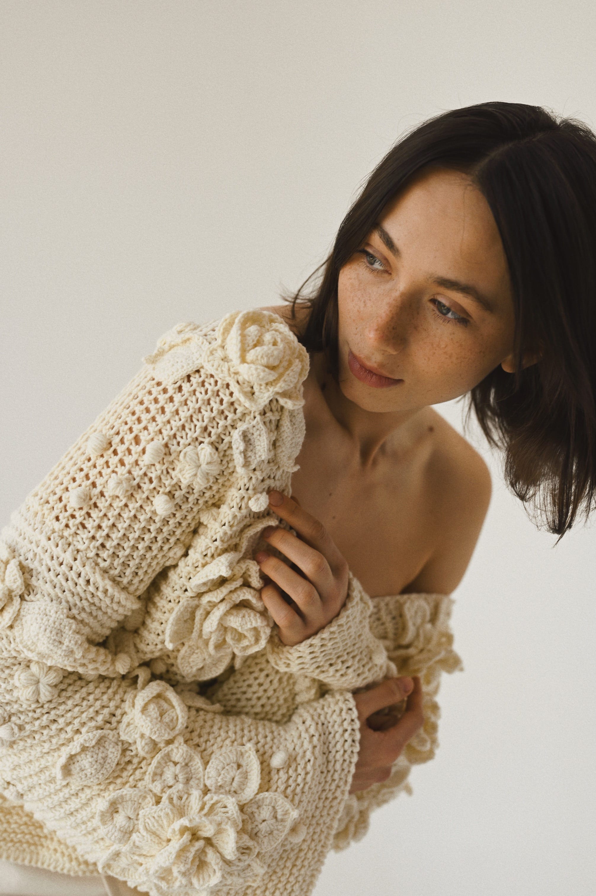 Dark-hair woman wearing beige sweater